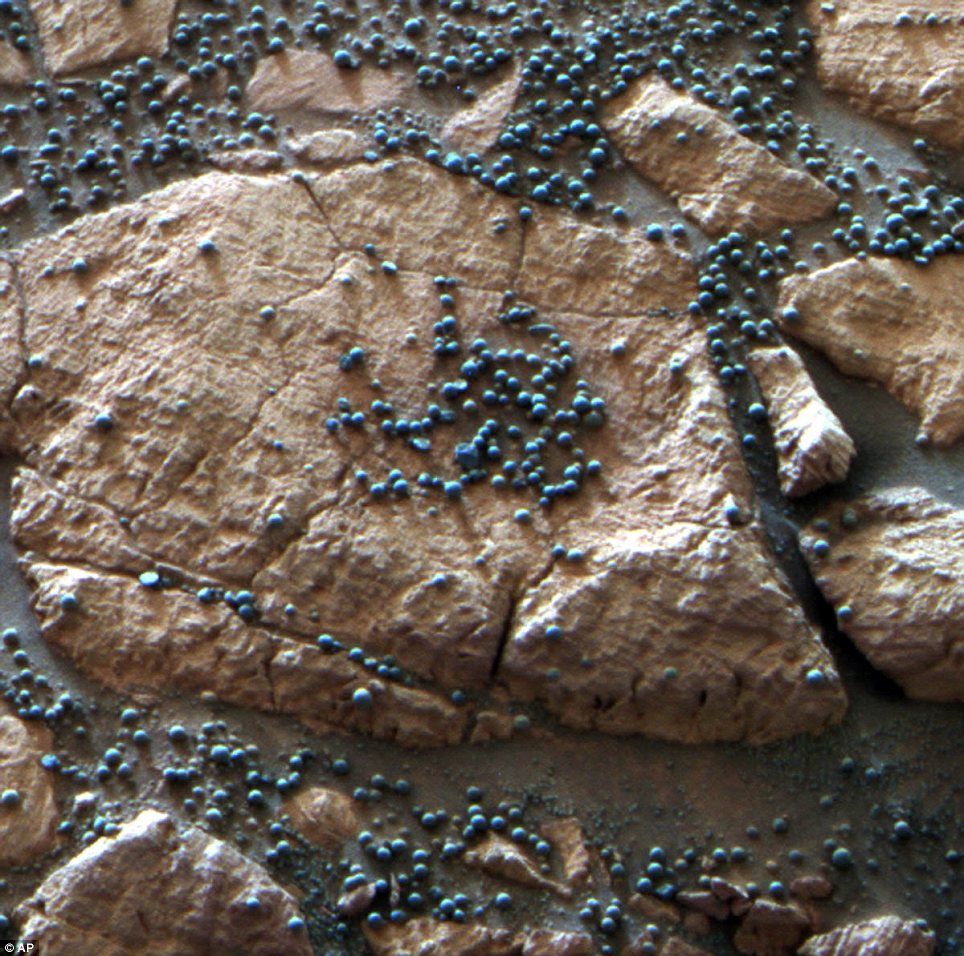 These loose, BB-sized, hematite-rich spherules are embedded in this Martian rock like blueberries in a muffin and released over time by erosion. The Mars Rover Opportunity found this cluster of them at its Eagle Crater landing site and analyzed their composition with its spectrometers. Credit: NASA/JPL-Caltech/Cornell University