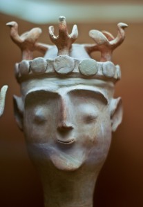 Minoan clay figurine at the Archaeological Museum in Heraklion with birds on her diadem.
